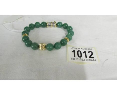 A 14 ct gold jade/jadite bracelet.