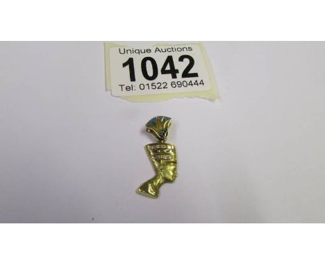 An Egyptian Nefertiti pendant (tests as possibly 24 k gold) 2.8 grams.