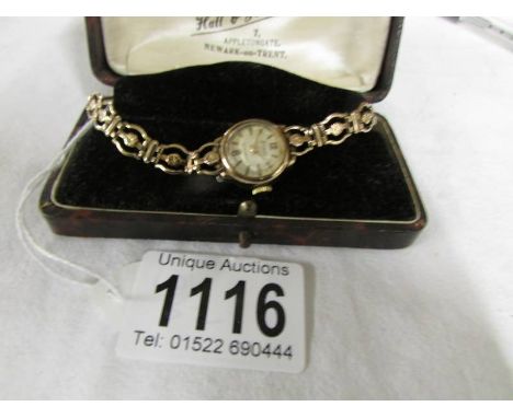 An Accurist ladies gold wrist watch.* COndition report*Lot 1116: 12.3 grams. Strap is stamped 375. Wound to the limit.