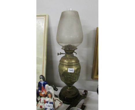 A Victorian brass oil lamp complete with shade.