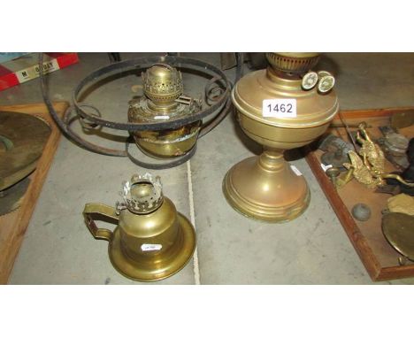 A hanging oil lamp and two other oil lamps.