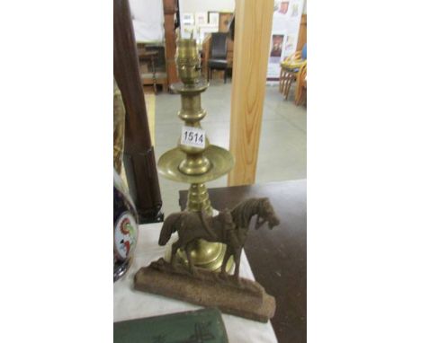 A brass lamp base and a cast iron horse door stop.