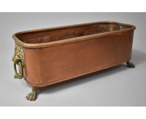 A Small Copper and Brass Rectangular Planter with Lion Mask Handles and Four Claw Feet, 31cm Long 