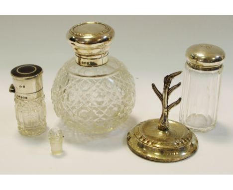 A silver topped scent bottle with stopper, Birmingham 1909; a silver ring tree, Birmingham 1924; a silver topped cut glass pe