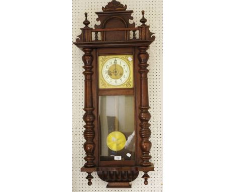 A Mahogany Vienna wall clock, brass dial, enamelled chapter ring, Arabic numerals, turned pilasters.