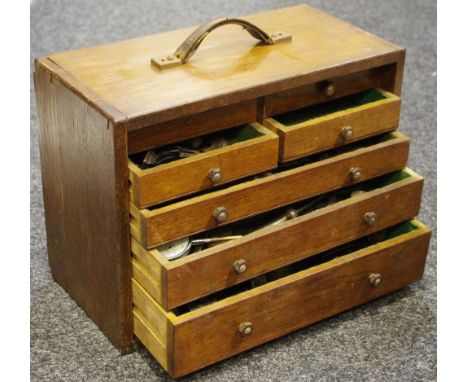 An Engineer's cabinet and tools including a Mercer dial test depth gauge, calipers, tap wrench and taps, etc