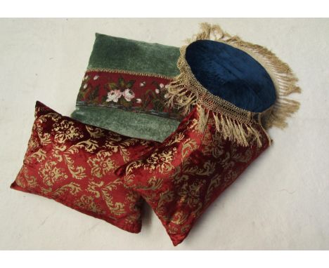 Four vintage velvet cushions, two puce velvet with gilt flock style design, royal blue with deep fringing and mid green with 