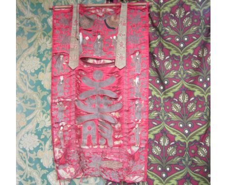 Oriental 19th Century scarlet silk temple/wall hanging, the textile is flanked by multiple figures embroidered in silk and me