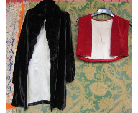 Two items of early 20th Century clothing to include a scarlet silk velvet cropped waistcoat and a black velvet coat with an e