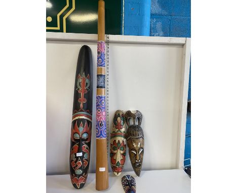 A selection of Aboriginal Tribal wooden masks and a large didgeridoo, shipping unavailable