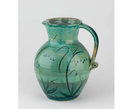 † PHILIP LEACH (born 1947) for Springfield Pottery; a large slipware jug with scroll handle covered in green glaze with iron 