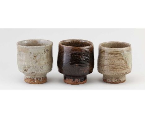 JIM MALONE (born 1946); a trio of stoneware yunomi partially covered in different glazes, impressed JM and L (for Lessonhall)