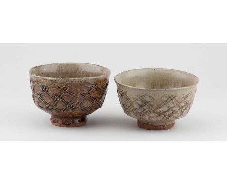 JIM MALONE (born 1946); a near pair of stoneware chawan covered in green ash and iron glaze with paddled decoration, impresse