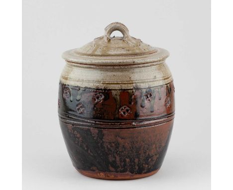 JIM MALONE (born 1946); a stoneware jar and cover partially covered in tenmoku breaking to kaki glaze with green ash top and 