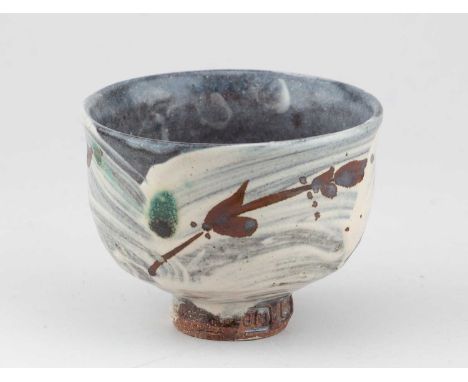 † JIM MALONE (born 1946); a stoneware chawan covered in brushed slip with iron decoration and copper green spots, impressed J