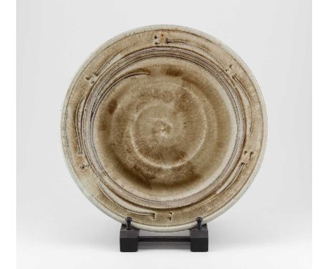 JIM MALONE (born 1946); a stoneware charger covered in green ash glaze with incised decoration, impressed JM and L (for Lesso