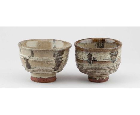 JIM MALONE (born 1946); a near pair of stoneware chawan covered in nuka and iron glaze with incised decoration, impressed JM 