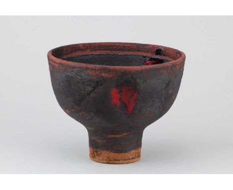 † ROBIN WELCH (1936-2019); a stoneware pedestal bowl partially covered in black glaze with red and black enamel decoration, i