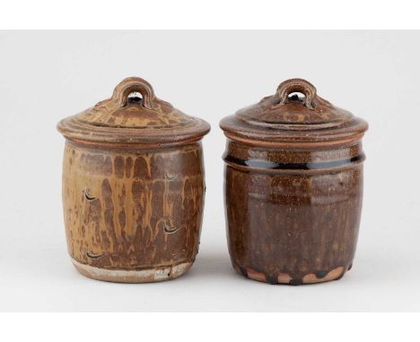 JIM MALONE (born 1946); a near pair of stoneware jars and covers covered in ochre and iron glaze, impressed JM and L (for Les