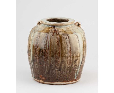 JIM MALONE (born 1946); a faceted stoneware jar with lug handles covered in green ash and kaki glaze with nuka top, impressed