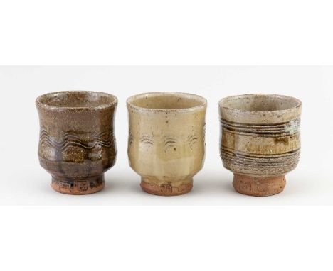 JIM MALONE (born 1946); a trio of stoneware yunomi covered in different glazes, impressed JM and L (for Lessonhall) marks, ta