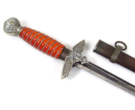 A Third Reich 2nd Pattern Luftwaffe dagger by Eickhorn, having aluminium pommel with Swastika, a deep orange celuloid handle 