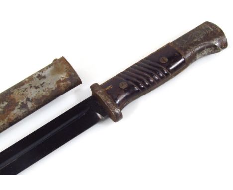 An early to mid 20thC bayonet and scabbard, marked CUIF and 4599 to the shape blade, with shape metal grip and inverted pomme