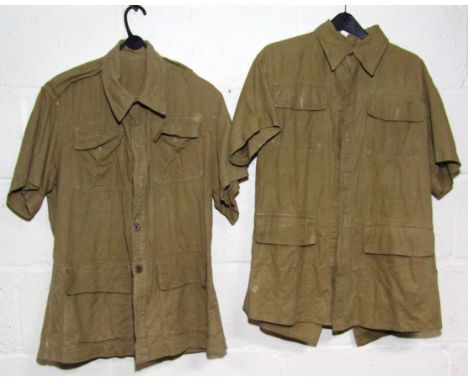 Two WWII British Army Bush shirts, one having manufacturer's label The Lurcan Weaving Company 1943 with broad arrow mark.