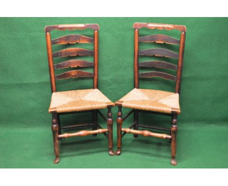 Set of six oak ladder back country chairs having shaped top rail and shaped back rails, supported on turned uprights leading 