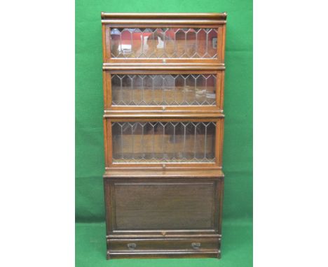 Oak Globe Wernicke sectional bookcase having three leaded glazed stepped sections over single solid panelled door section, st