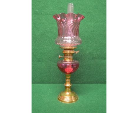 Cranberry glass and brass oil lamp having clear glass chimney and later Cranberry shade over a Cranberry glass reservoir, sta