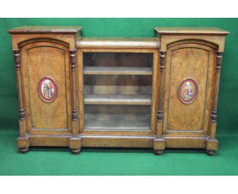 Carved and inlaid burr walnut credenza having central glazed door enclosing two fixed shelves with velvet lining, flanked by 