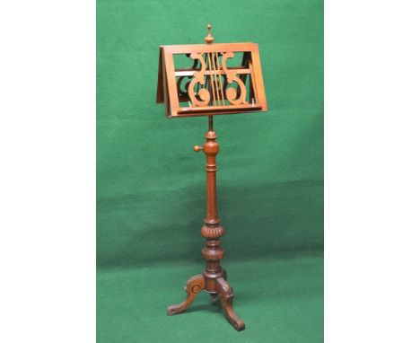 Victorian mahogany double music stand having turned finial over double sided pierced music racks, supported on a turned and r