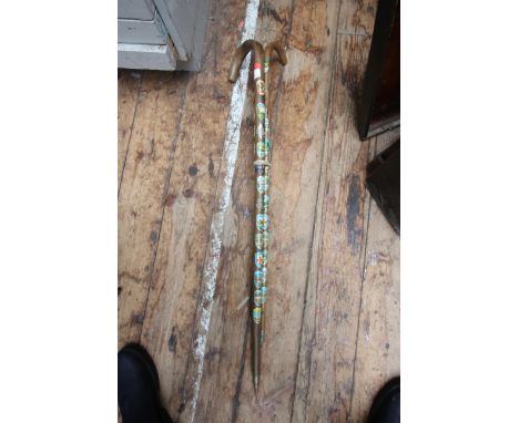 Pair of walking sticks, both with a collection of attached metal stick badges continental 