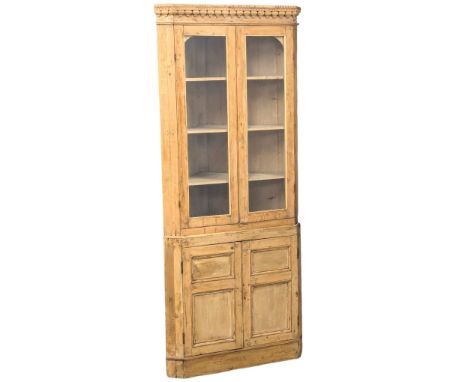 An Early 19th Century George III pine 2 piece corner cabinet with Neogothic cornice, architectural sunburst interior and moul