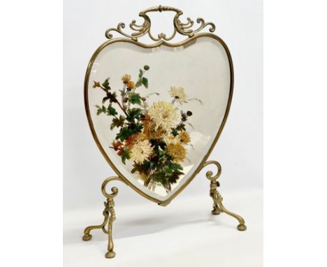 An Edwardian brass shield framed firescreen, with painted bevelled glass. 49x21x74cm