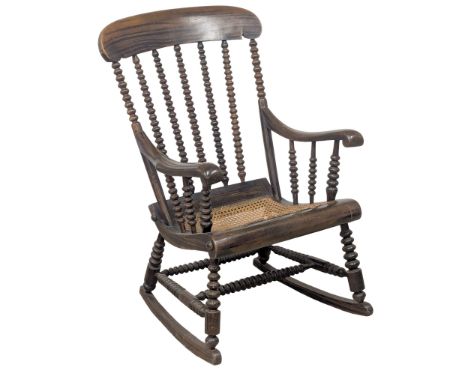 A Mid to Late 19th Century Victorian simulated rosewood Bobbin Turn rocking chair with bergere seat. Circa 1860-1890. 1