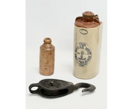 An Ansell Walsall rope pulley, a McAuley The Bonne Nuit Foot Warmer and an R Wright stoneware bottle.