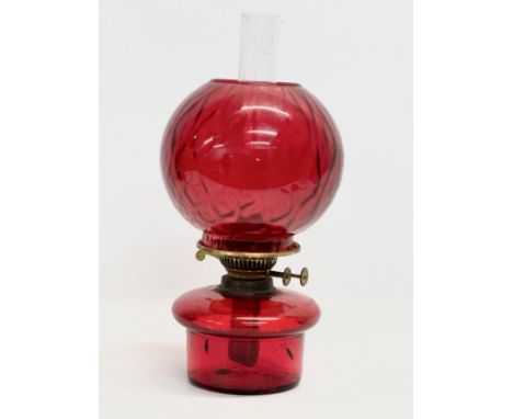 An Early 20th Century ruby glass oil lamp bowl and shade. 41cm