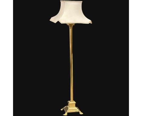 A brass standard lamp with Corinthian style column and lion paw feet. 167cm (10)