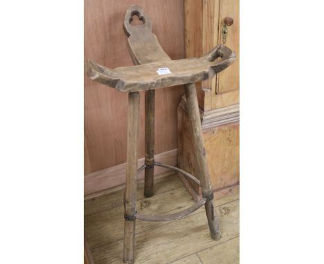 An elm three legged stool, W.50cm