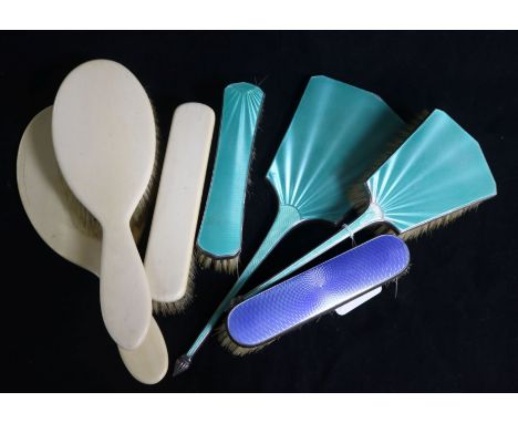 Four silver and enamel dressing set items and an early 20th century ivory dressing table set.