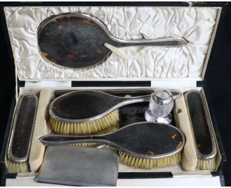 A 1920's cased silver and tortoiseshell six piece brush and mirror set, an aide memoire, a silver cigarette case and a match 