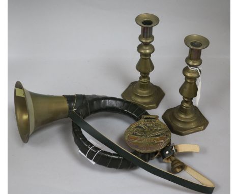 A pair of brass candlesticks, a horse brass and a hunting horn