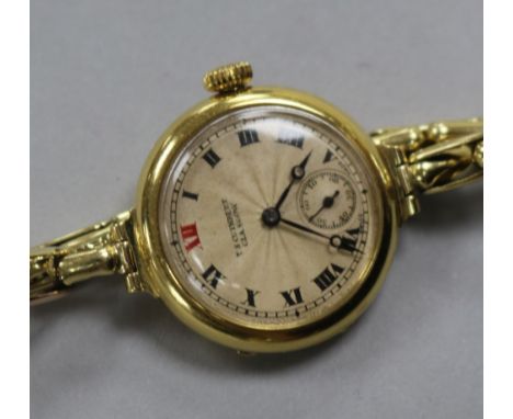 An early 20th century 18ct gold manual wind wrist watch retailed by T.s. Cuthbert, Glasgow, on 15ct gold flexible strap.