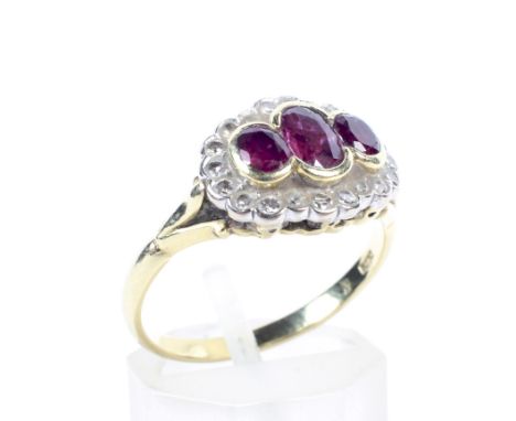 A vintage 18ct gold, ruby and diamond shaped-oval dress ring. The three graduated oval mixed-cut rubies rub-over set in yello