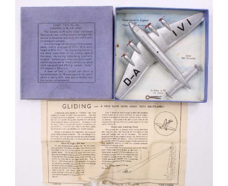 Dinky toys No. 62N Junkers Ju 90 Airliner, In silver body with red propellers, housed in the original blue lift off all card 