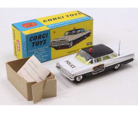 A Corgi Toys No. 481 Chevrolet Police Car, black and white body with black roof and red roof light, with Police Patrol sticke