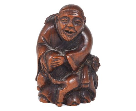 A Meiji Period Hardwood Netsuke of Boy and Father with Dog:The father holding an upturned gourd, with the boy hugging a dog, 