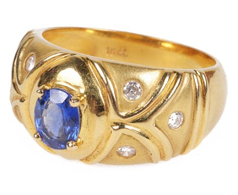 An 18ct Ceylon Sapphire 0.90ct Ring Set with Diamonds:Hallmarked 18ct,with central oval cut 0.90 ct sapphire in claw mounting